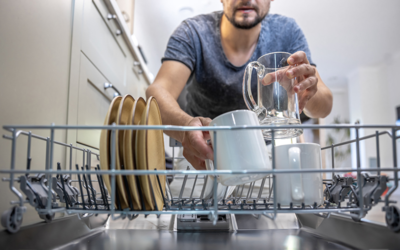 Người đàn ông xếp bát vào máy rửa bát có dung tích lớn tiện dụng
